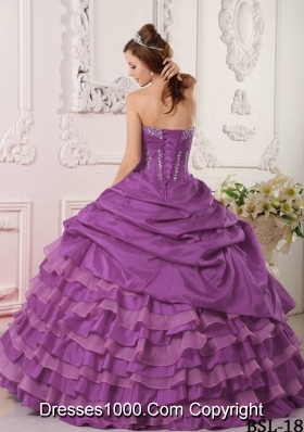 Purple Ball Gown Strapless Quinceanera Dress with Ruffled Layers and Beading