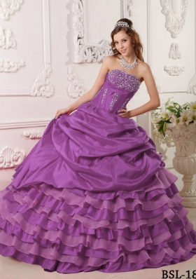 Purple Ball Gown Strapless Quinceanera Dress with Ruffled Layers and Beading