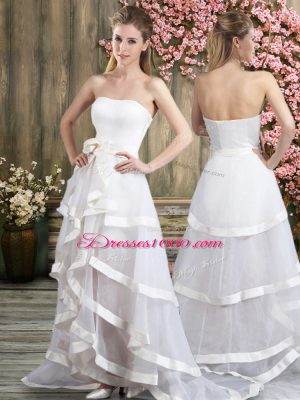 Sleeveless Tulle Sweep Train Backless Wedding Gowns in White with Ruffled Layers and Belt