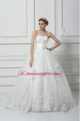 Captivating Sleeveless Tulle Brush Train Lace Up Bridal Gown in White with Lace and Appliques and Hand Made Flower