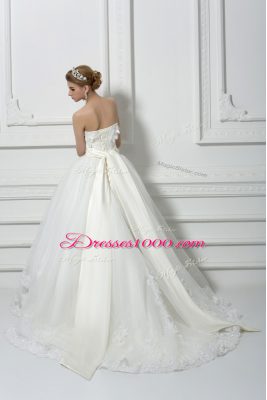 Captivating Sleeveless Tulle Brush Train Lace Up Bridal Gown in White with Lace and Appliques and Hand Made Flower