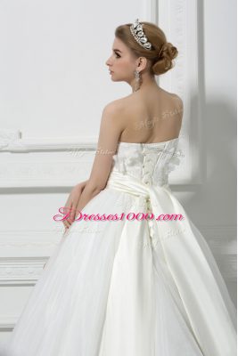 Captivating Sleeveless Tulle Brush Train Lace Up Bridal Gown in White with Lace and Appliques and Hand Made Flower